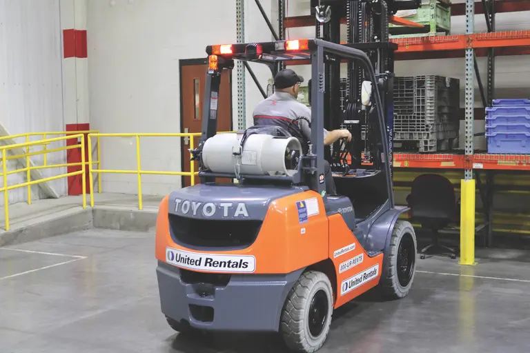 warehouse forklift orange in action