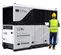 White Generac hydrogen powered fuel cell with a worker standing nearby