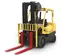 Front view of a yellow Hyster warehouse forklift with black tires, a propane tank, extended red forks and an open cabin.