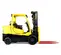 Side view of a yellow Hyster warehouse forklift with black tires, a propane tank, extended red forks and an open cabin.