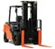 Front angled view of an orange and black warehouse forklift with extended forks and an open cabin.
