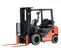 Front angled view of an orange and black Toyota warehouse forklift with a black mast, orange forks and an open cabin.