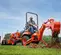 Orange and black KUBOTA 20-29 HP Backhoe Loader, 8 ft. Dig Depth