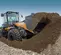 Orange and black Case Wheel Loader on a job site with dirt in the bucket