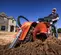 Orange Ditchwitch trencher with tracks