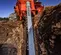 Orange Ditchwitch trencher with tracks