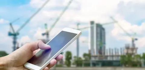 cell phone in front of worksite