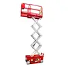Side view of a red and silver scissor lift extended vertically, with safety rails.