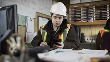 person in hard hat at desk